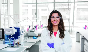 A happy scientist with goggles in the lab A happy scientist with goggles in the lab