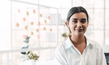 Business person with a whiteboard behind them in a modern office