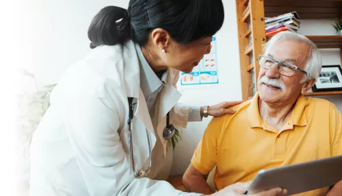 Doctor having conversation with an elderly patient