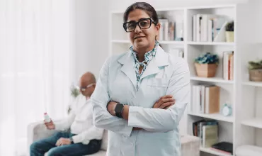 Doctor with patient in the background Doctor with patient in the background