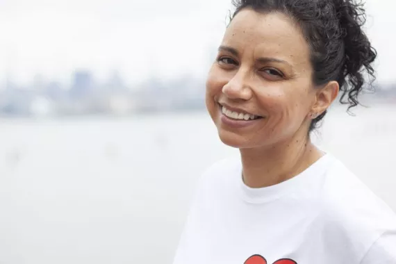 Meet Gisela, a kidney disease patient. A kidney patient is smiling at the camera.
