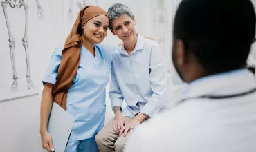 A nurse and patient engaged in a hug A nurse and patient engaged in a hug