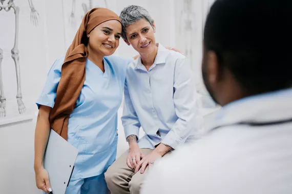 A nurse and patient engaged in a hug A nurse and patient engaged in a hug
