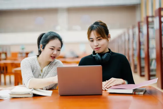 NEST- Nurturing Excellence, Strengthening Talent Two students studying together